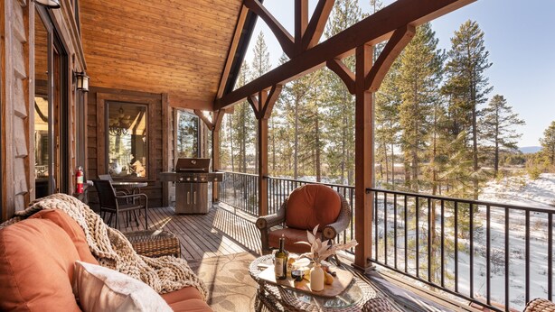 A wooden deck with outdoor seating, a grill, and a view of a snowy landscape. - Big Pine by Avantstay Stunning Secluded Oregon Home w/ Hot Tub (Bend)