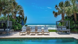 A poolside area with lounge chairs and a view of the ocean. - Promenade by Avantstay Beach Front Mansion w/ Breathtaking Views & Pool! (Miramar Beach)
