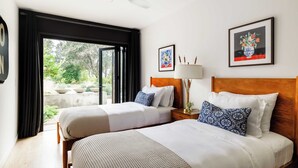 A hotel room with two beds, a ceiling fan, a window with curtains, and artwork on the walls. - Marquee By Avantstay Modern Stylish Estate w/ Pool & Entertainers Courtyard (Sonoma)