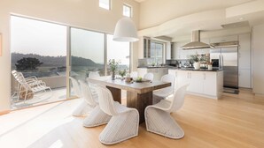 A modern kitchen with a large island, white cabinetry, and stainless steel appliances. - Seascape by Avantstay Spacious Contemporary Oasis in Del Mar (Del Mar)