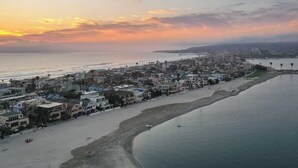 A coastal cityscape with a beach, buildings, and a pier. - Bay View II by Avantstay Ocean View Mission Beach Home on the Sand! (San Diego)