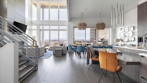 A modern kitchen with a dining area, large windows, and a staircase. - Silverado by Avantstay Snowboarder's & Skiers Paradise w/ Hot Tub, Views & Easy Slope Access! (Park City)