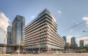 Situated at an urban intersection, this building offers a unique corner design with a combination of glass and concrete facades.