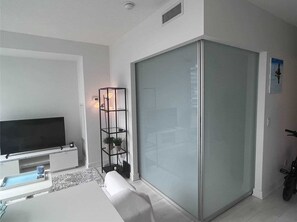Relax in this stylish living room with a flat-screen TV, comfortable sofa, and convenient side table.