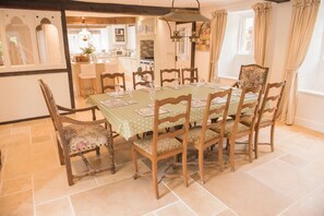 Enjoy meals with family and friends in this cozy dining area, surrounded by comfortable chairs and a beautifully set table.