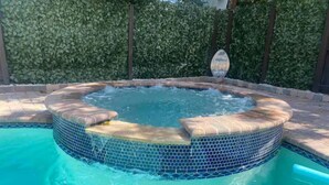 A hot tub with a tiled edge and a small pool area. - 4BR/3BA Mini-Resort Near Beach heated Pool & Spa (Pompano Beach)