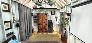 A compact living space with a kitchenette, a wooden cabinet, and a ceiling fan. - Stabbin Cabin #2 on Grant Island-HotTub,Boat,Pets (BRANTINGHAM)