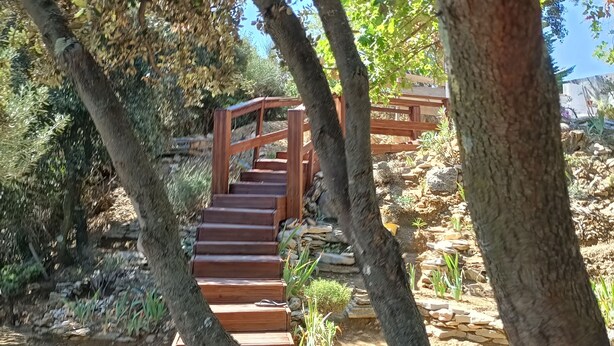 A wooden staircase leading up to a wooden deck surrounded by trees and plants. - SERENA 🏡.<br><br>Near the Pont d'Avignon.<br>Palace of the Popes.<br>Pont du Gard, Nîmes (Tavel)