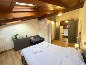 A bedroom with a bed, bedside table, dresser, and a mirror. - Cloud of Parma// of the Duchy 1 (Parma)