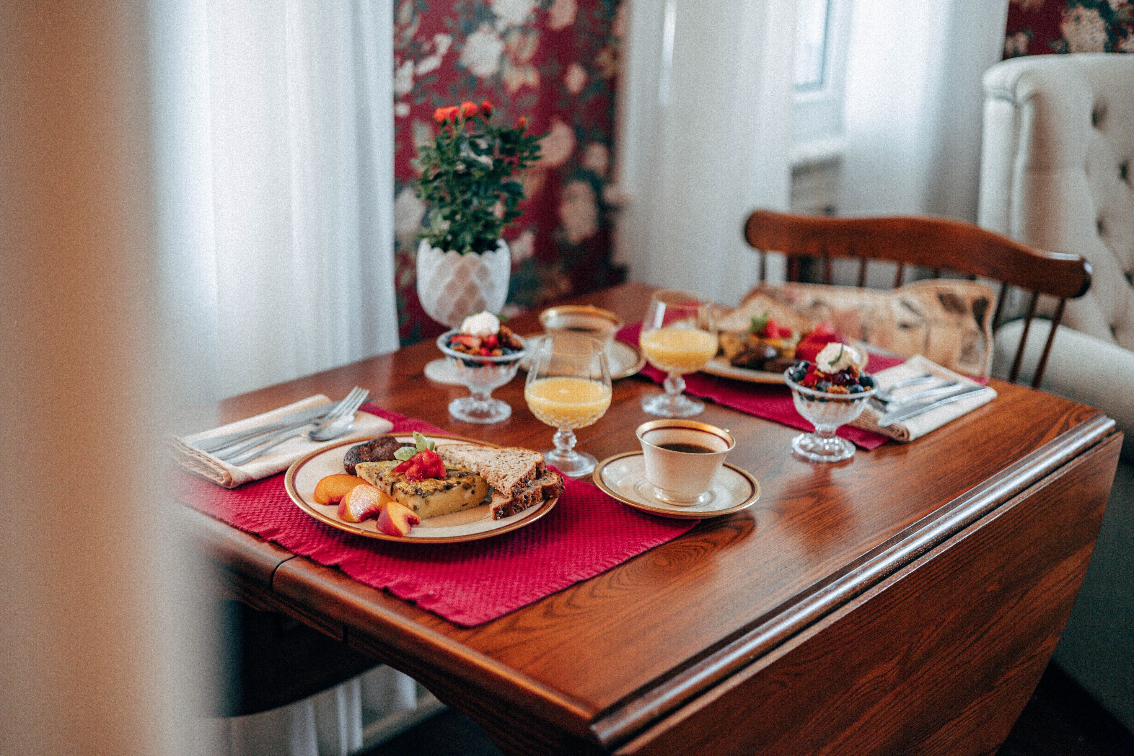 A dining table with a variety of breakfast items including toast, fruit, and beverages.