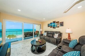 Relax in this stylish living room with a balcony offering ocean views.