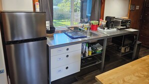 A kitchen with stainless steel appliances, a sink, and storage cabinets.