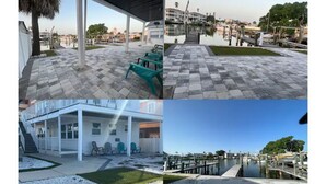 A building with a covered patio area, a pool, and a waterfront view.