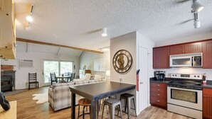 A spacious kitchen with a central island, wooden cabinets, and modern appliances. - Spectacular Pocono's Getaway Near EVERYTHING!!! (Tannersville)