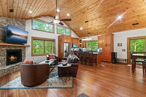 Cozy living area with fireplace, comfortable seating, and large windows offering views of the surrounding landscape.