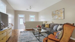 A living room with a sofa, coffee table, and TV.