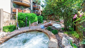A spa area with hot tubs surrounded by natural landscaping and a wooden fence. - 🏔️Ski Access~Hot Tub~Studio Premier 102🏔️ (Snowmass Village)