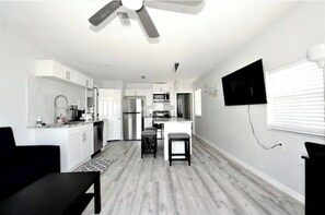 Enjoy meals in the kitchen with a dining table for two, a microwave, and a sink at the island.