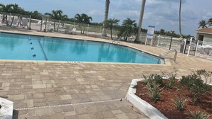 A swimming pool with a white fence, palm trees, and a 'No Diving' sign. - EBT 801 C (Fort Myers Beach)