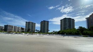 A beach with high-rise buildings in the background. - EBT 801 C (Fort Myers Beach)