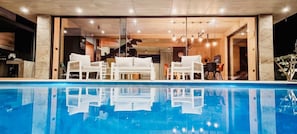 An infinity pool, a heated pool, sun loungers