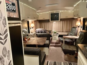 Relax in a cozy space with a sofa, chair, and TV for a comfortable stay.