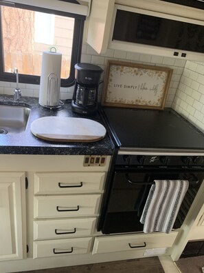 Enjoy cooking in this well-equipped kitchen with an oven, sink, and coffee maker.