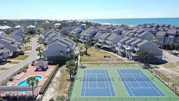 A residential area with multiple two-story houses, a tennis court, and a swimming pool.