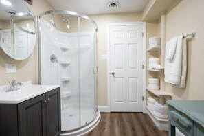 Combined shower/bathtub, towels, soap, toilet paper