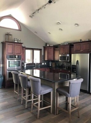 Enjoy cooking in this well-equipped kitchen with a central island and bar stools.