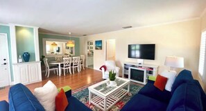 TV connectée, cheminée, livres, écrans d'ordinateur