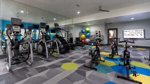 A gym with various cardio machines, weightlifting equipment, and exercise balls. - Total Relaxation and Tranquility - Perfect space for family or work . (The Woodlands)