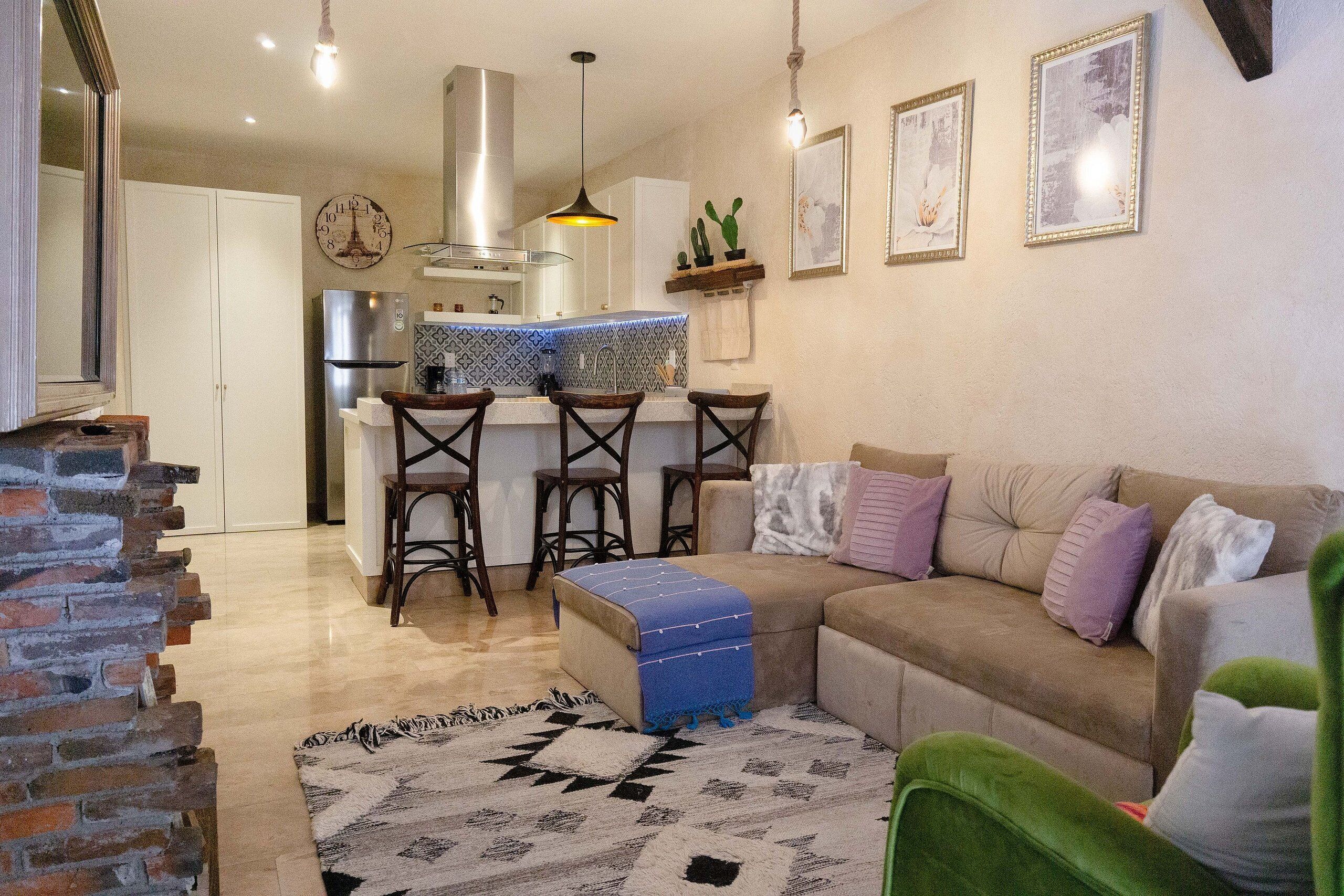 A cozy living room with a sofa, a coffee table, and a patterned rug.