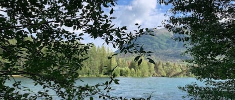 A lake surrounded by trees and hills.