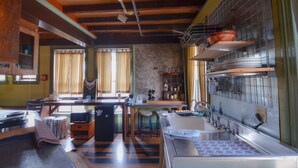 A kitchen with wooden beams, a sink, and a stove. - Michie Hostel (Providence)