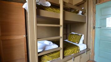 Una camera con letto a castello, una porta di legno e una porta blu chiaro.