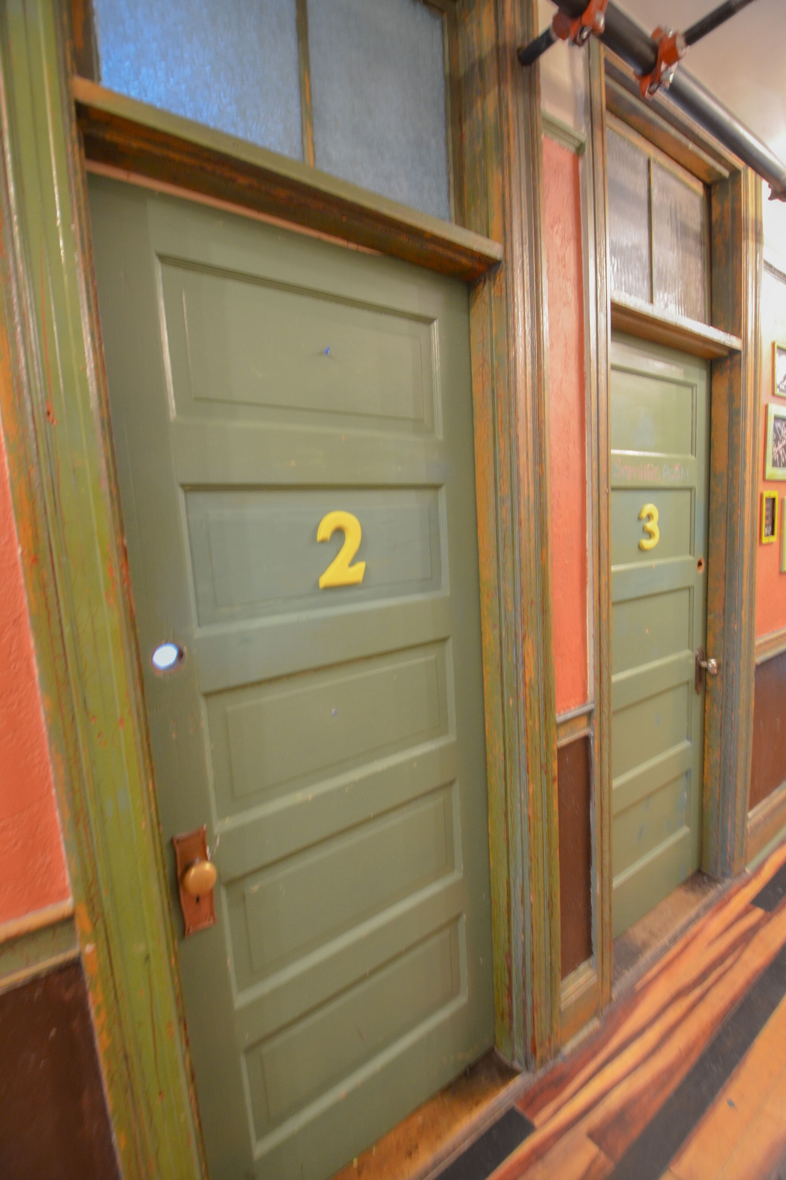 A row of doors with numbers 2 and 3, indicating room numbers.
