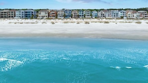 A beachfront hotel with multiple-story buildings, a sandy beach, and ocean views. - Oceanfront, Pool+hot Tub, Game Room, Views Steps to Beach Lido by Avantstay (Hilton Head Island)