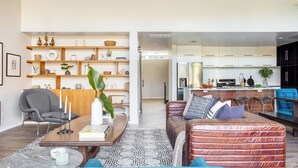 Ein modernes Wohnzimmer mit Sofa, Couchtisch und Bücherregal.
