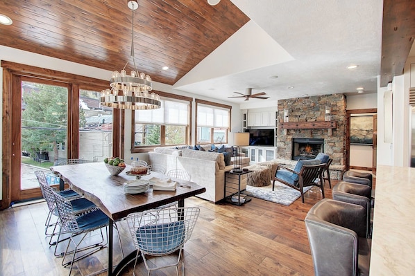 Enjoy a spacious living area with a dining table, comfortable seating, and a fireplace.