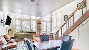 A cozy living room with a dining table, chairs, a sofa, and a staircase. - Columbia Place 5 by Avantstay Ski-in/ski-out Unit in Great Location! (Telluride)