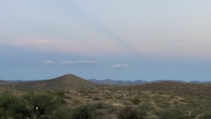 A desert landscape with sparse vegetation and distant mountains under a clear sky. - Cheerful 2 Bed & 1Bath unfinished home with beautiful views (Cordes Lakes)