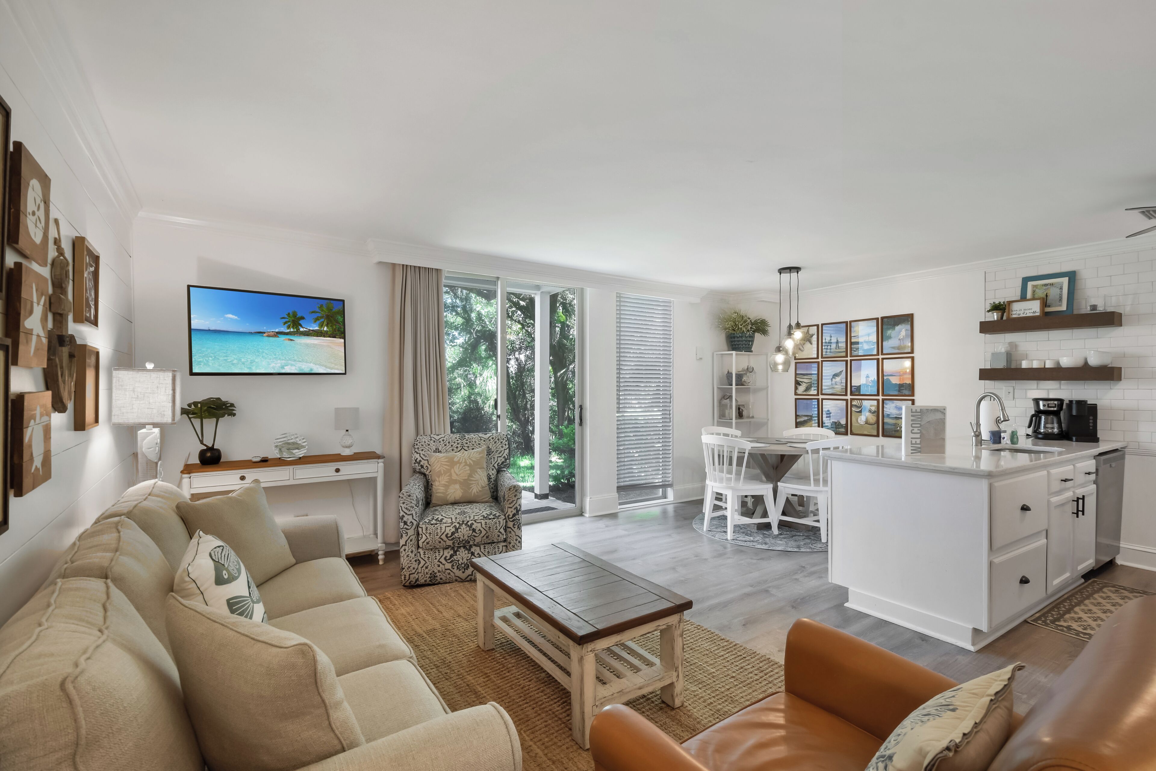 A modern living space with a sofa, coffee table, and dining area.