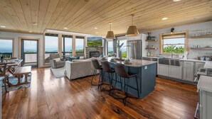 A spacious kitchen with a large island, wooden flooring, and a view of the outdoors. - Spectacular View 3 Bd Luxury Smoky Mountain Cabin (Sevierville)