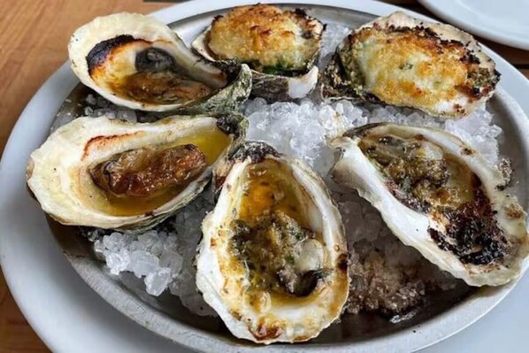 A plate of oysters on ice. - Stunning waterfront home with big yard & dock! Voted #1 rental in all of RI! (South Kingstown)
