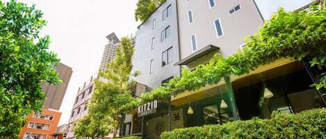 A modern building with a sign reading "Kitzio House."
