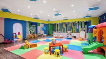 Kids can play and learn in this vibrant play area with a play mat, play table, slide, and climbing wall.