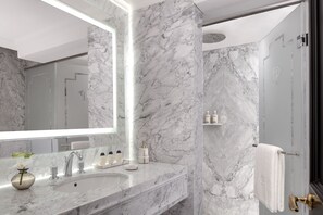 A modern bathroom with a marble sink, large mirror, and a shower area. - The Plaza Doha, LXR Hotels & Resorts (Doha)