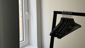 A room with a window, a door, and a black hanger rack. - Good times in St. Goar (Sankt Goar)