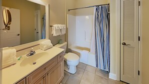 A bathroom with a sink, toilet, and bathtub.